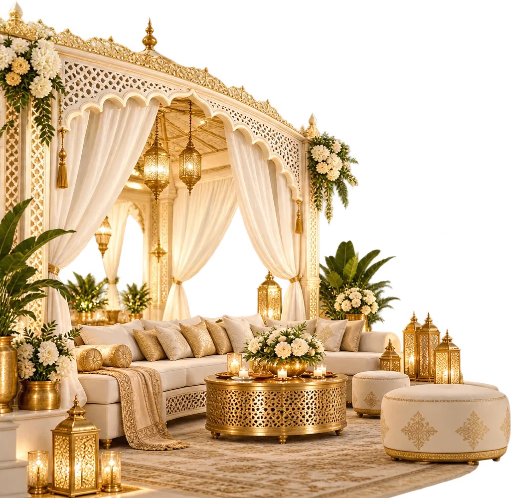 An ivory and gold gazebo lounge with cushioned sofas, a carved brass table, lanterns and white florals